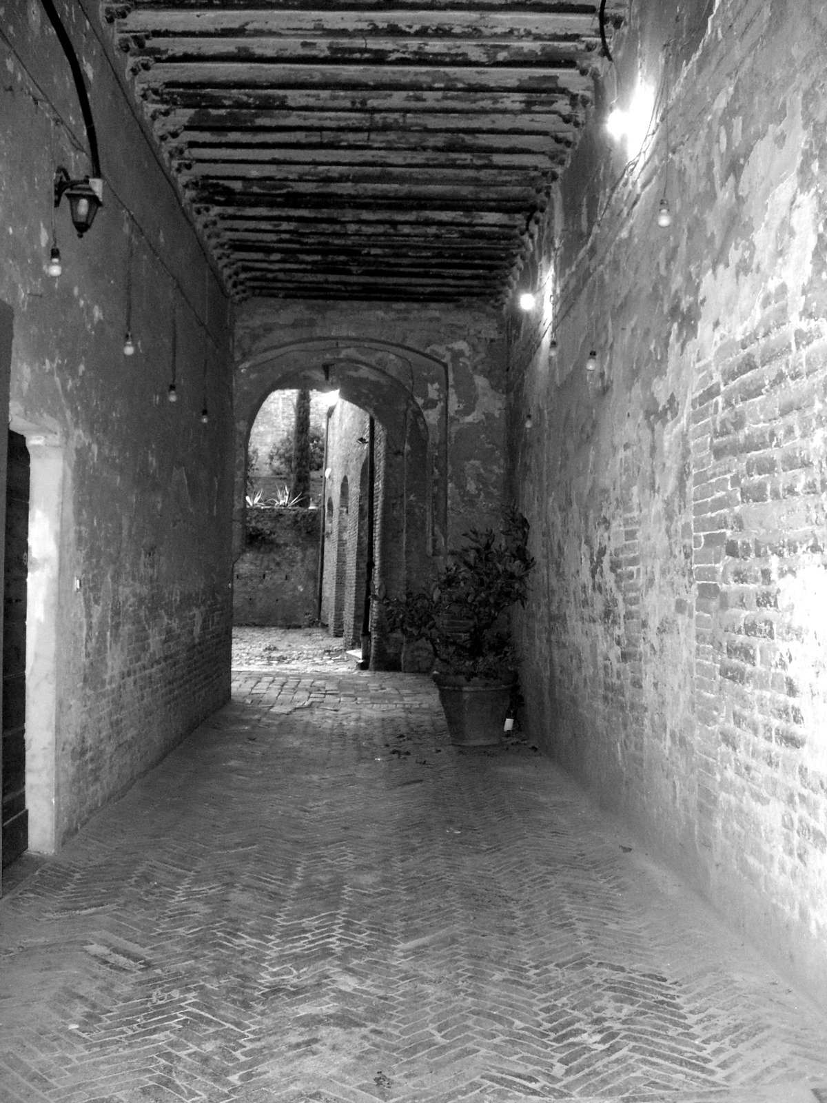 The covered passage with the wooden beams before the works