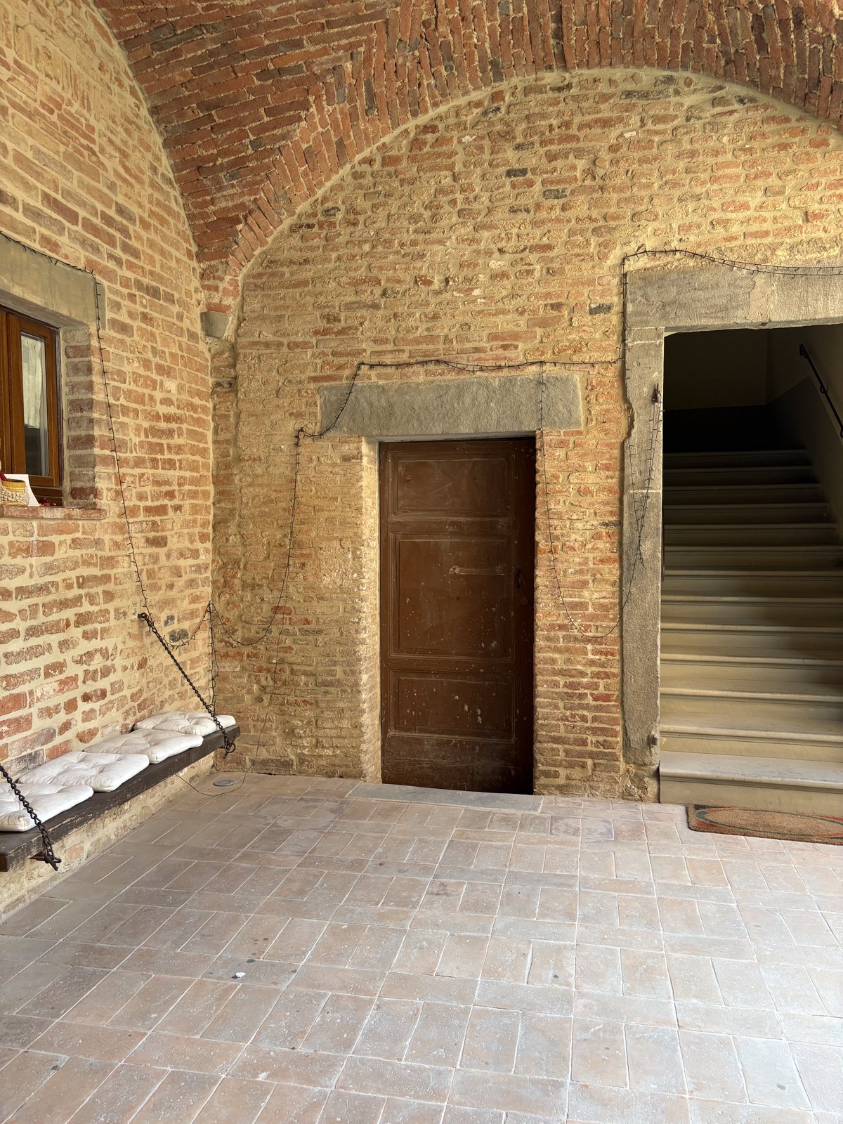 The wooden door and the staircase today, with the restored brickwork