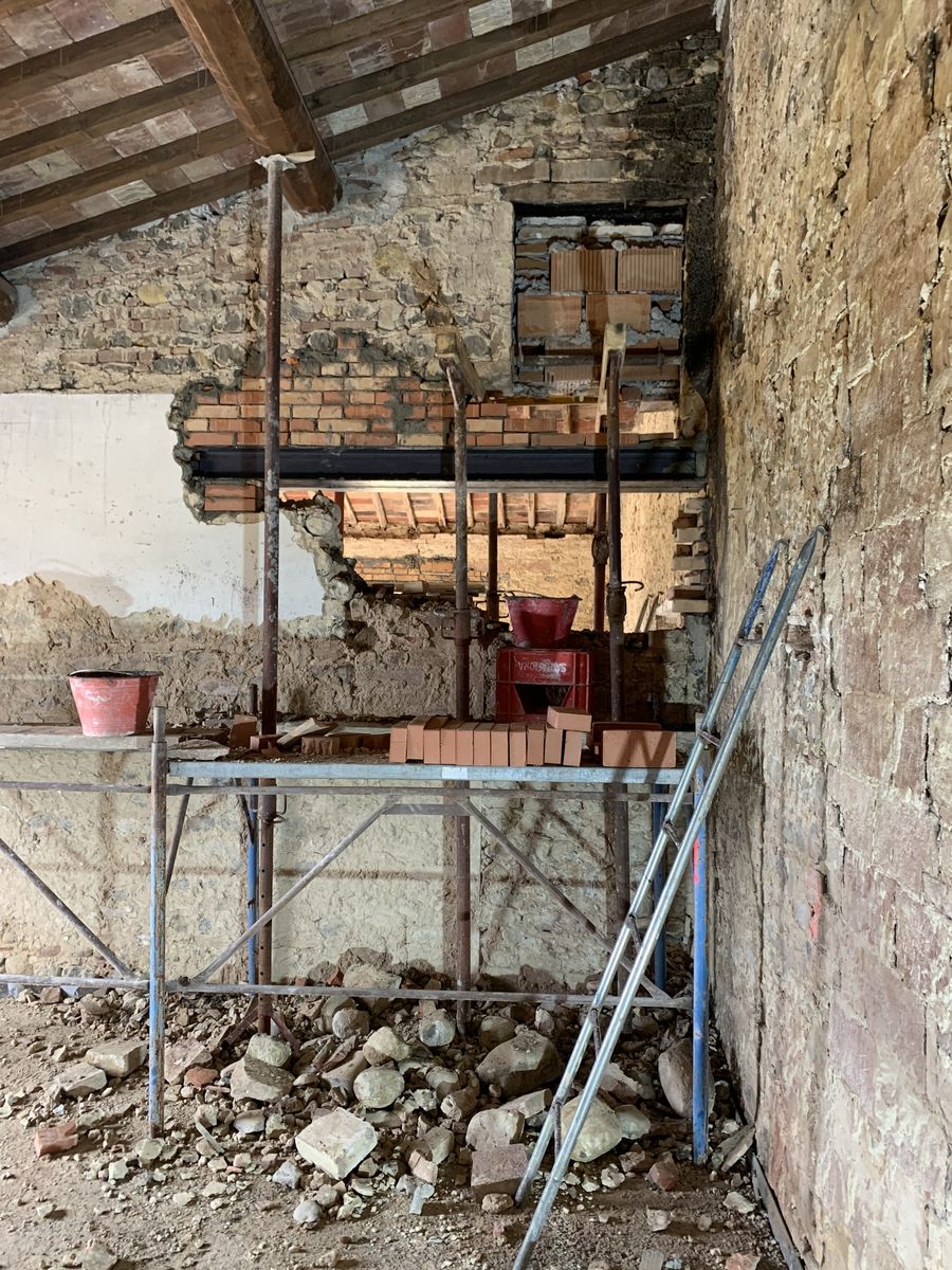 Opening in a stone wall, framed with new bricks