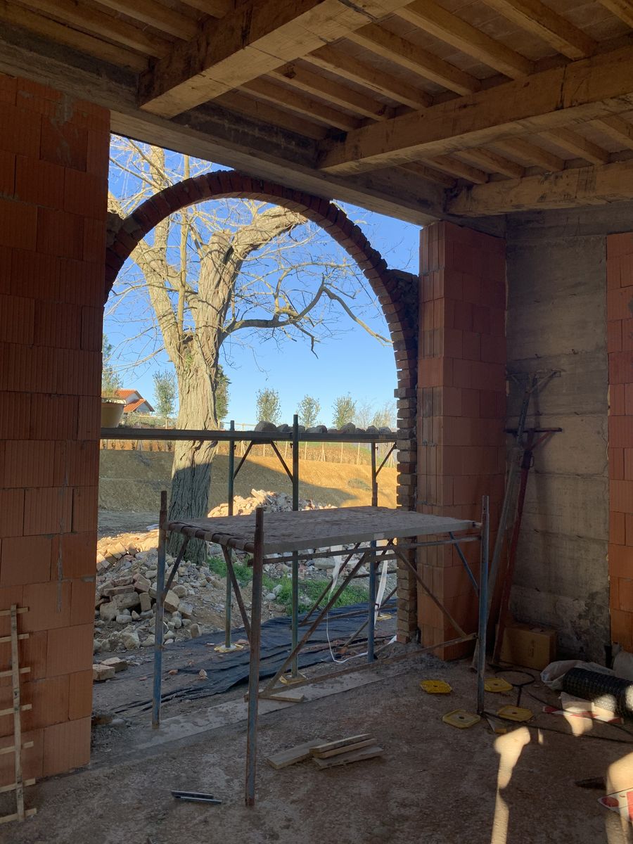 A rebuilt brick arch, seen from inside the portico