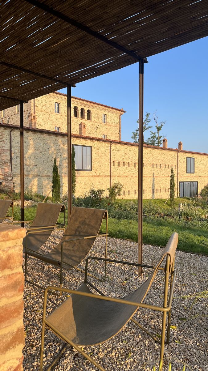 Pergola with seating beside the farmhouse