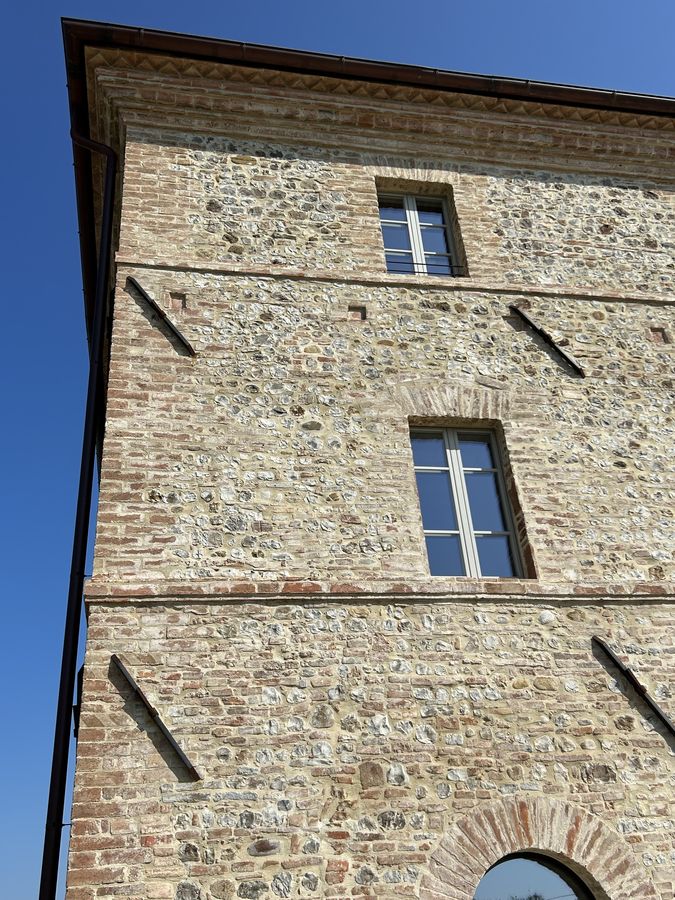 Corner of the farmhouse with the mixed stone and brick masonry