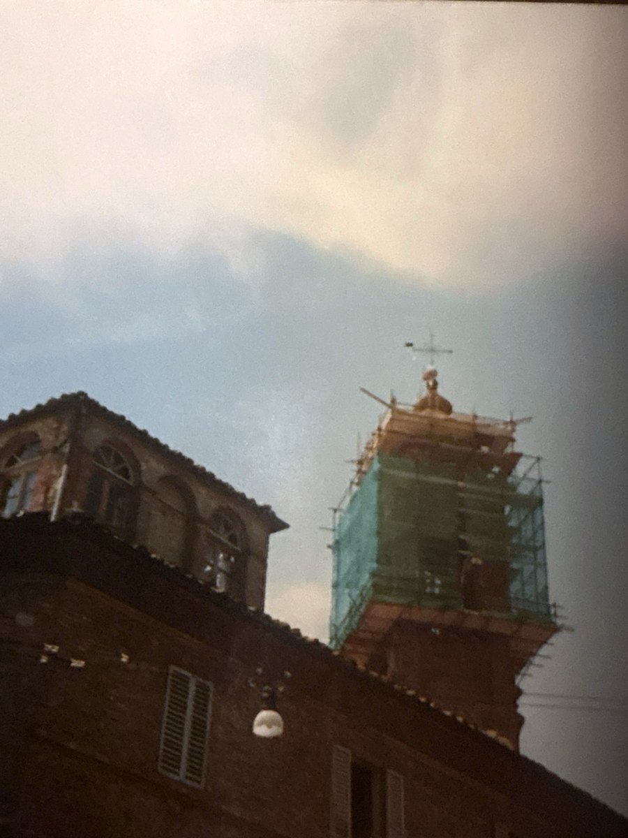 The Cathedral bell tower with scaffolding and green netting, in a colour photograph from the 1980s