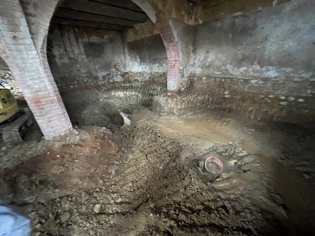 The stable floor dug out between the brick pillars