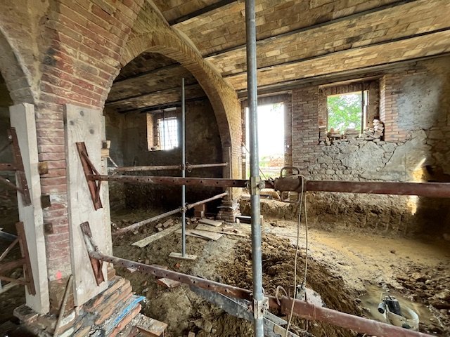 A brick arch held up by timber and steel props