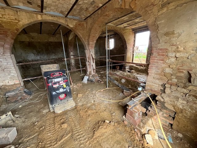 The old stables on the ground floor, with the masonry arches and the works under way