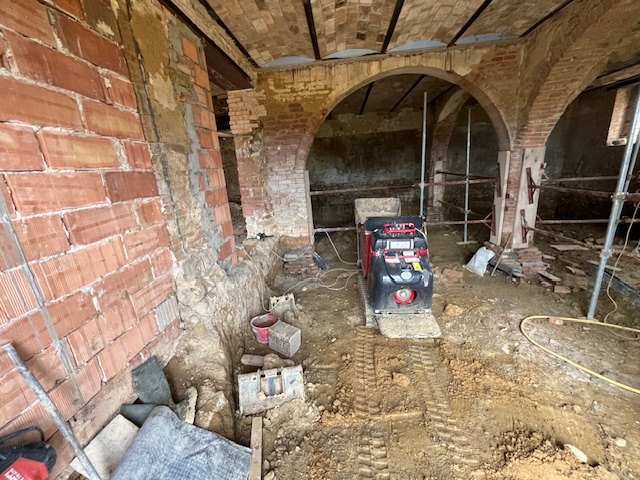 The brick arches of the stables and the floor dug out during the works