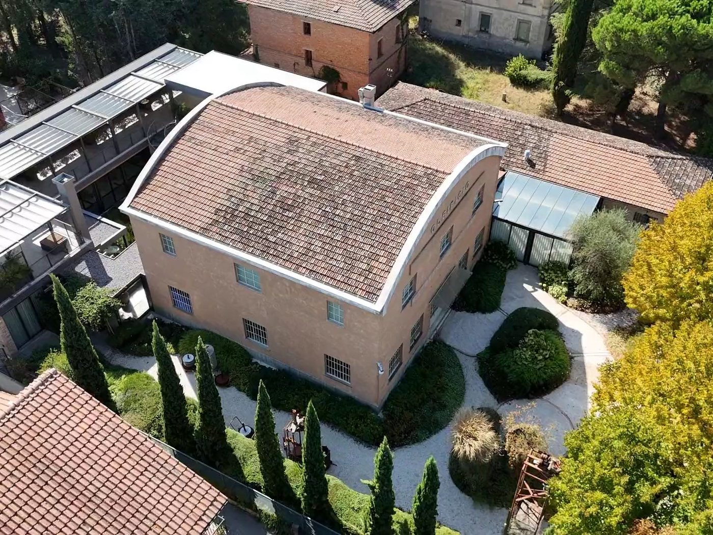 The former olive oil mill of Molino 49 seen from a drone, with the courtyard and the cypresses