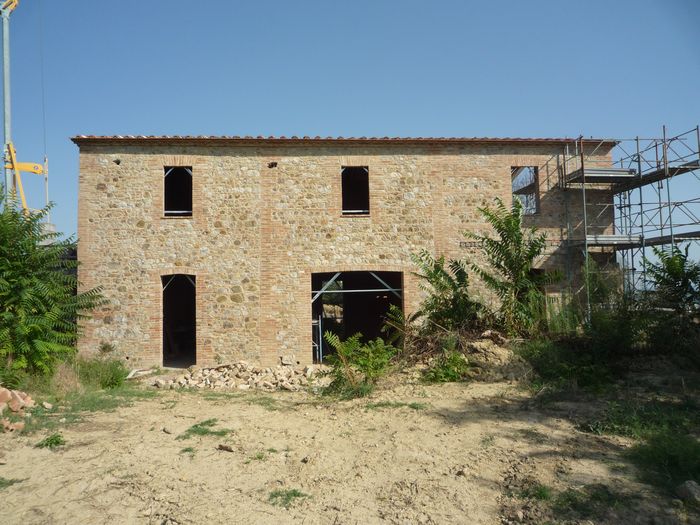 The stone façade with the openings still to be closed