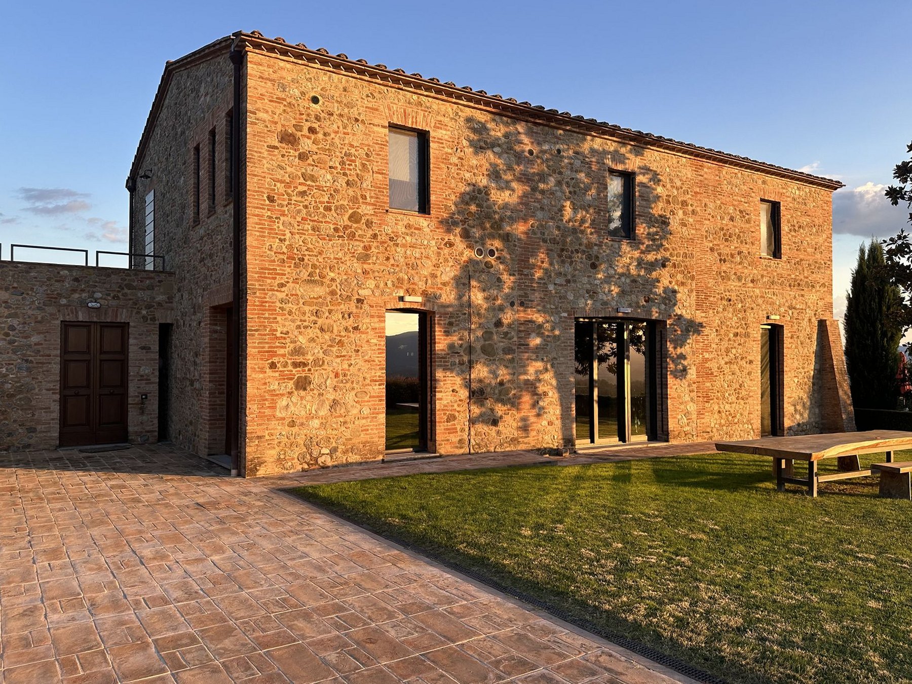 The Vigna Nuova farmhouse at sunset, with the lawn