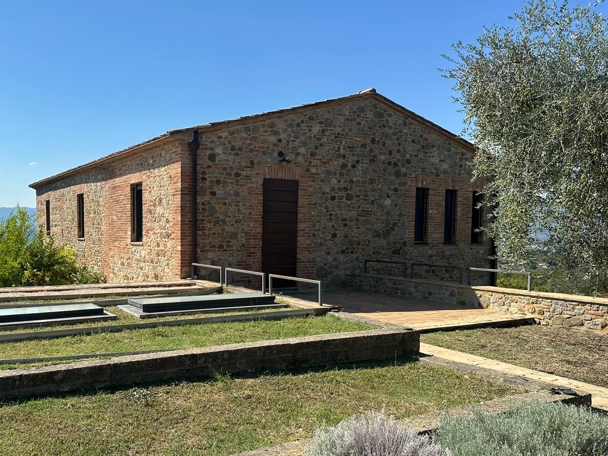 The same building today, in stone and brick, with the lawn, the skylights and the lavender